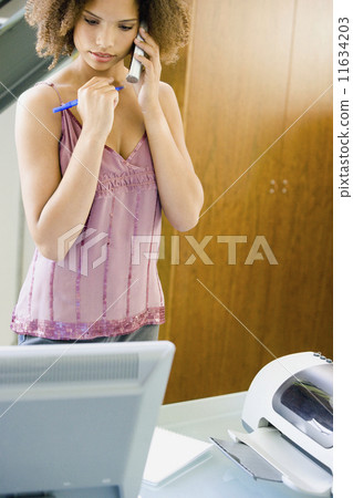 African businesswoman talking on telephone 11634203
