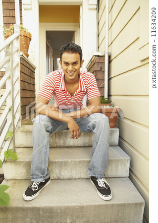 Indian man sitting on steps Indian man sitting on steps 11634209