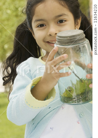 Young girl showing captured bug Young girl showing captured bug 11634210