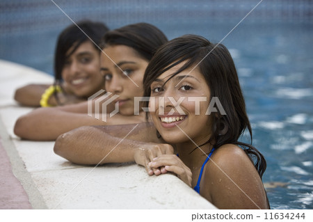 Hispanic teenaged girls in swimming pool 11634244