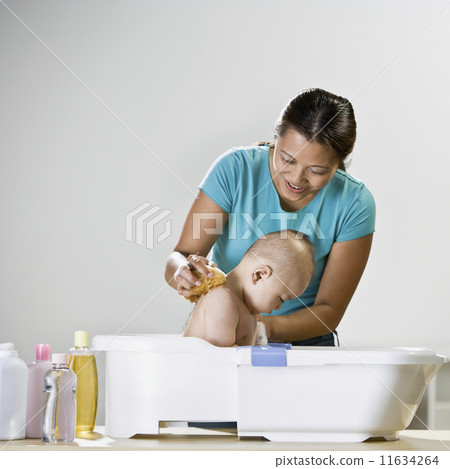 Asian mother bathing baby 11634264