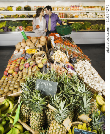Hispanic couple shopping in grocery store 11634273