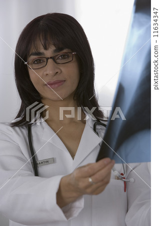 Female doctor holding x-ray 11634347