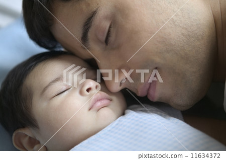 Close up of father sleeping with baby Close up of father sleeping with baby 11634372