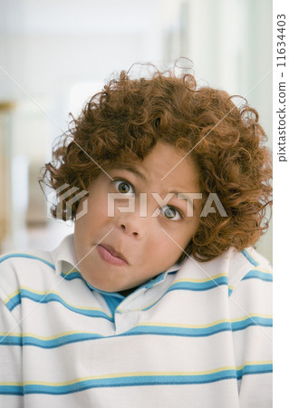 Mixed Race boy shrugging shoulders 11634403