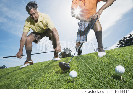 Multi-ethnic men on golf course 11634415