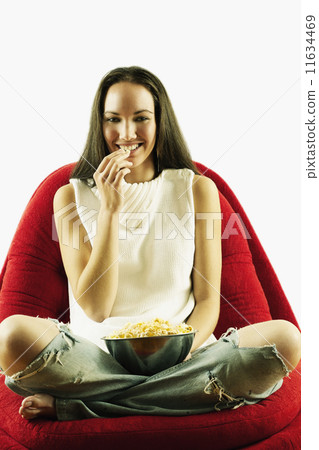 Portrait of woman eating popcorn Portrait of woman eating popcorn 11634469