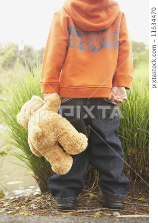 Rear view of young boy with teddy bear Rear view of young boy with teddy bear 11634470