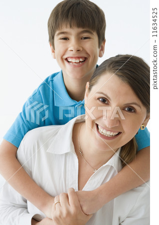 Mother carrying her son on her back Mother carrying her son on her back 11634525