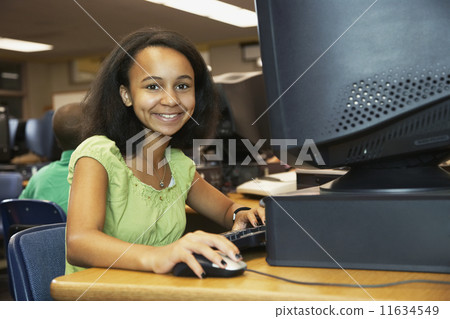 African American girl using school computer African American girl using school computer 11634549