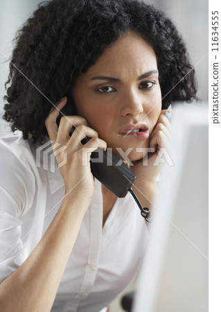 African businesswoman talking on telephone African businesswoman talking on telephone 11634555