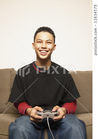 Portrait of teenage boy with game controller 11634578