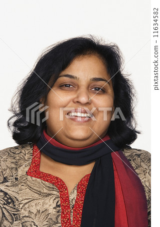 Close up studio shot of Indian woman smiling Close up studio shot of Indian woman smiling 11634582