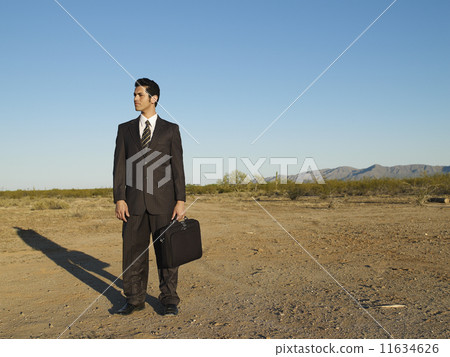 Hispanic businessman in middle of nowhere 11634626