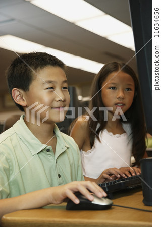 Asian students using school computer 11634656
