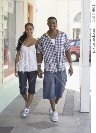 Multi-ethnic couple holding hands 11634661
