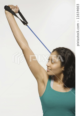 Indian woman using exercise band Indian woman using exercise band 11634663
