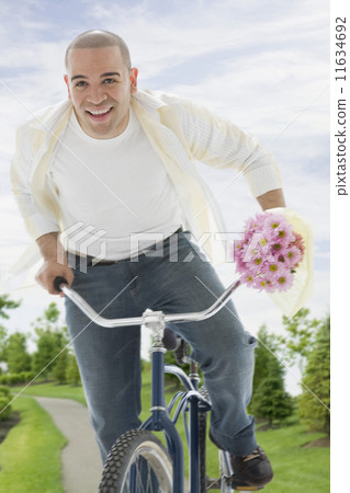 African American man riding bicycle 11634692