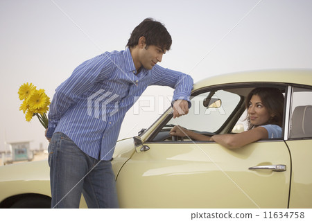 Man giving flowers to woman 11634758
