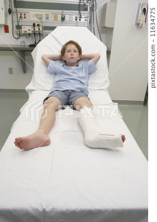 Young boy with broken leg laying in hospital bed Young boy with broken leg laying in hospital bed 11634775