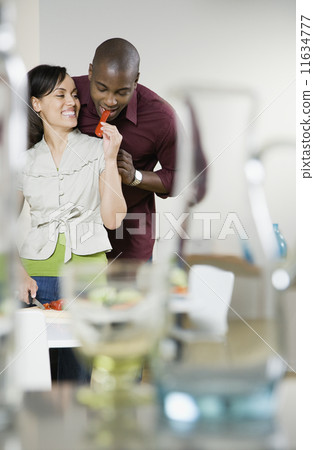 Mixed Race woman feeding boyfriend Mixed Race woman feeding boyfriend 11634777