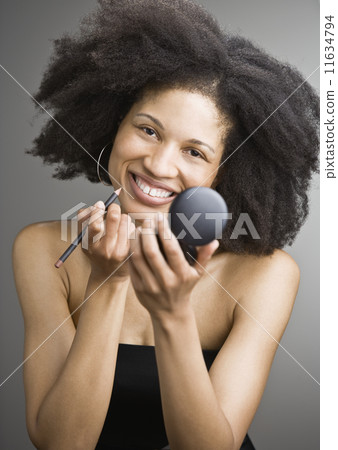 African American woman applying makeup 11634794