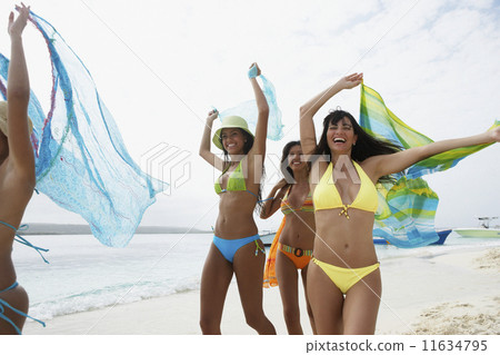 South American women running on beach 11634795