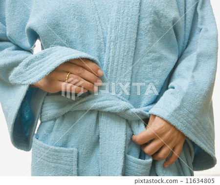 Close up of woman tying bathrobe 11634805
