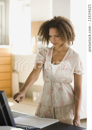 African businesswoman pointing at computer African businesswoman pointing at computer 11634825