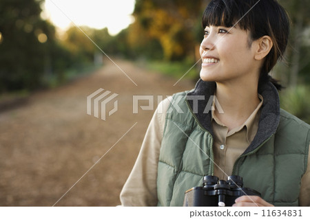 Asian woman holding binoculars 11634831