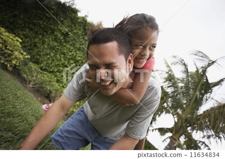 Hispanic father and daughter playing 11634834