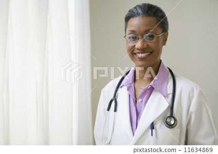 African American doctor standing and smiling 11634869