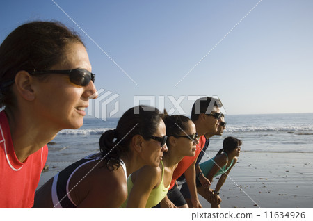 Multi-ethnic runners racing at beach Multi-ethnic runners racing at beach 11634926