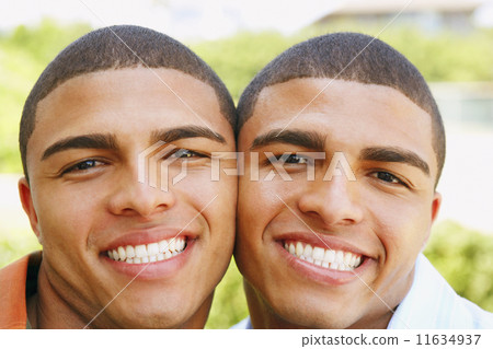 Close up of Hispanic twin brothers smiling Close up of Hispanic twin brothers smiling 11634937