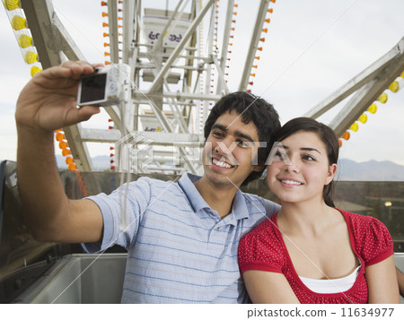Multi-ethnic teenaged couple on carnival ride 11634977