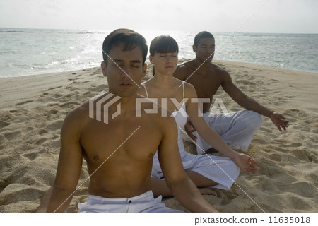 Multi-ethnic friends meditating on beach Multi-ethnic friends meditating on beach 11635018