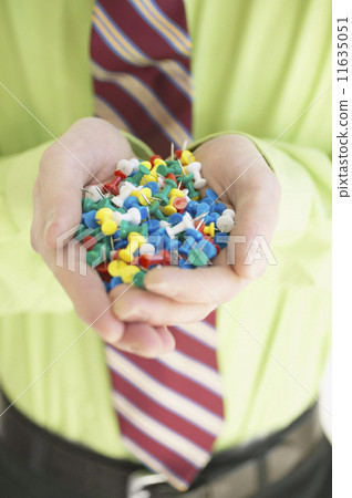Businessman holding push pins 11635051