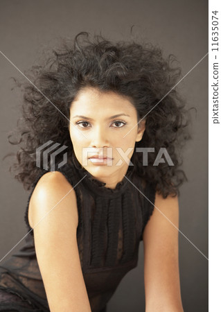 Portrait of Indian woman with curly hair Portrait of Indian woman with curly hair 11635074