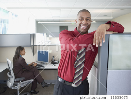 Businessman smiling for the camera in office space 11635075