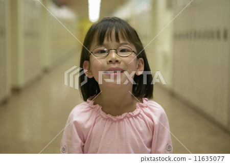 Young girl smiling in school hallway 11635077