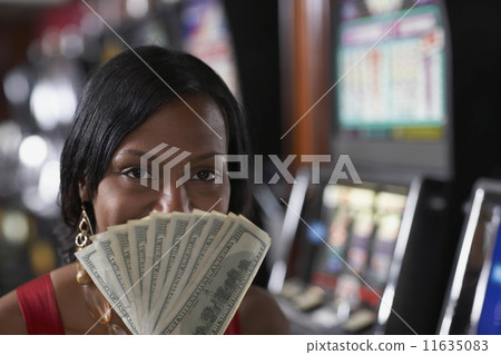 Mixed Race woman holding money Mixed Race woman holding money 11635083