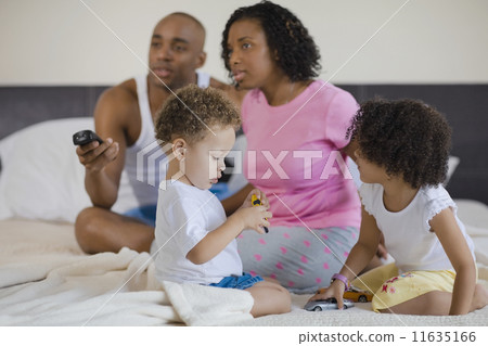 African family watching television and playing 11635166
