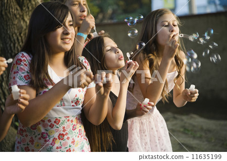 Hispanic girl blowing bubbles Hispanic girl blowing bubbles 11635199