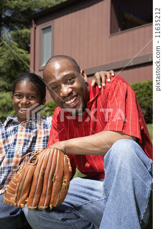 African father and son with baseball glove 11635212