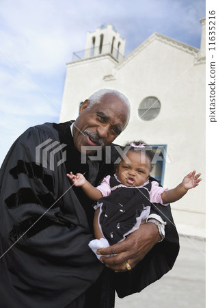African American Reverend holding baby 11635216
