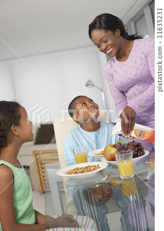 African American mother and children at breakfast 11635231