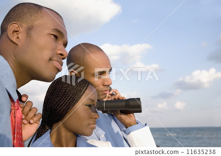 African businesspeople looking through binoculars 11635238
