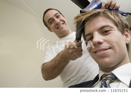 Male hair stylist working on male client Male hair stylist working on male client 11635251