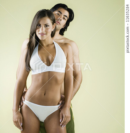 Multi-ethnic couple wearing bathing suits 11635284