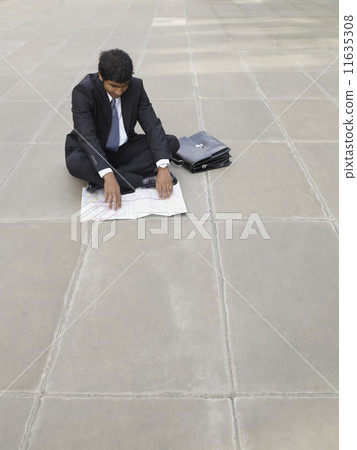 Indian businessman looking at map 11635308
